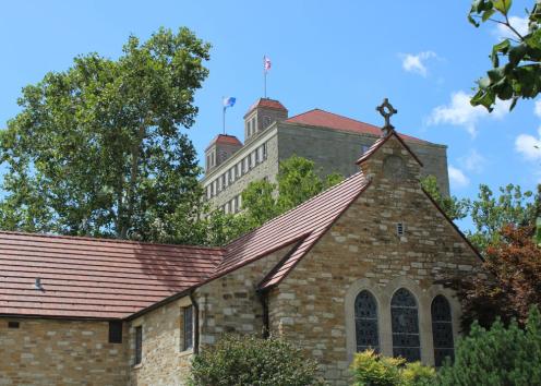 Danforth Chapel's North side including the cross, 3 stained glass windows, and Fraser Hall to the left side