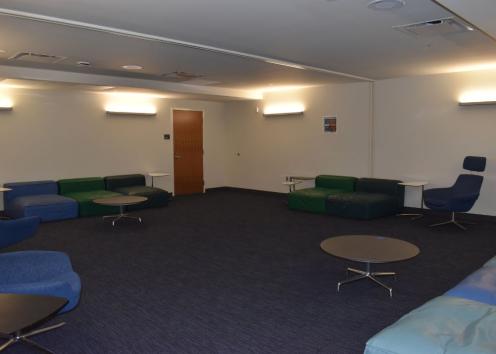 A room filled with comfortable seating and personal tables 